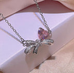 Silver-Plated Cubic Zirconia Bow and Heart Necklace and Earring Set - ORYX TREND NecklaceElevate your style with our charming pink heart and bow jewelry set. This beautiful necklace and earring set is adorned with sparkling rhinestones and a cubic zirconia heart, making it an ideal accessory for any outfit. It's a perfect gift for someone special.Default Title#