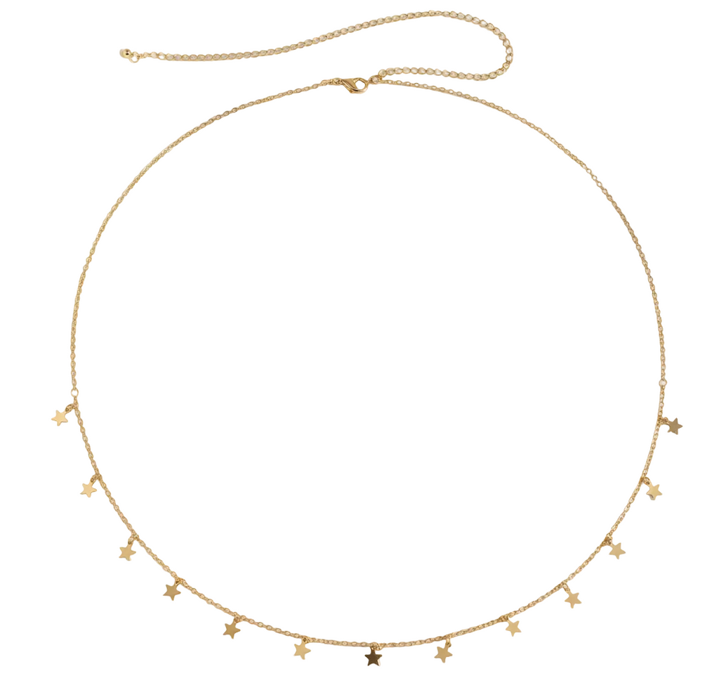 Gold necklace with star-shaped pendants on a white fabric background
