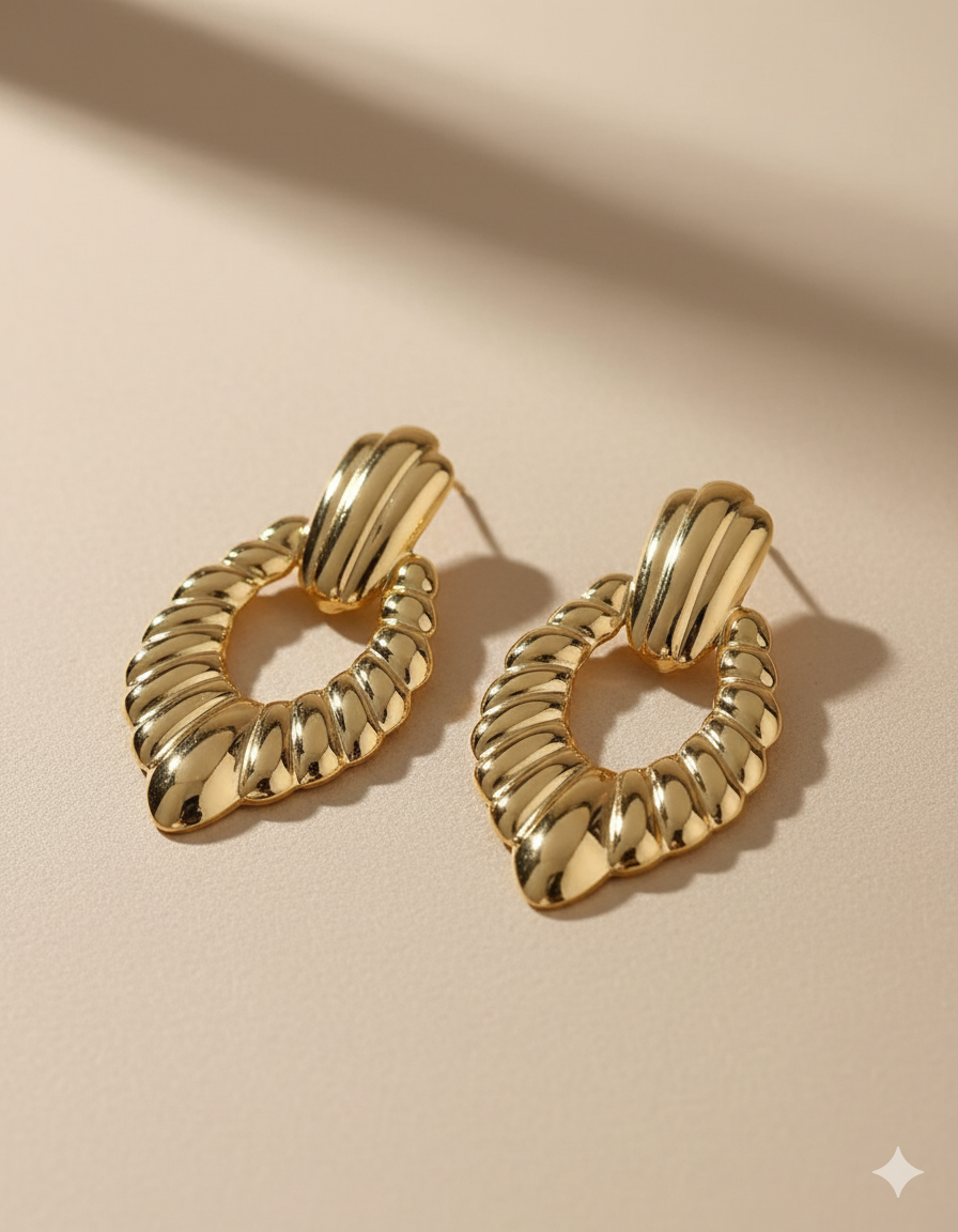 Statement Gold-Tone Croissant Textured Drop Earrings - ORYX TREND EaringMake a bold impact with these unique drop earrings. They feature a chunky, highly textural design, often referred to as a "croissant" or ribbed texture, in a rich gold tone. The earrings are secured with a simple, polished stud or post back. Made from durable stainless steel, these fashionable pieces are resistant to tarnishing, offering a high-end look with long-lasting quality. Perfect for elevating any outfit.Default Title#