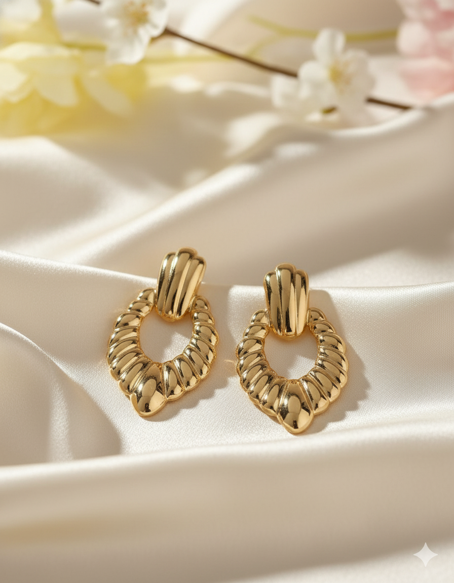 Statement Gold-Tone Croissant Textured Drop Earrings - ORYX TREND EaringMake a bold impact with these unique drop earrings. They feature a chunky, highly textural design, often referred to as a "croissant" or ribbed texture, in a rich gold tone. The earrings are secured with a simple, polished stud or post back. Made from durable stainless steel, these fashionable pieces are resistant to tarnishing, offering a high-end look with long-lasting quality. Perfect for elevating any outfit.Default Title#