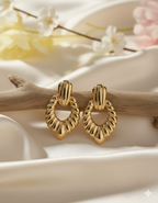 Statement Gold-Tone Croissant Textured Drop Earrings - ORYX TREND EaringMake a bold impact with these unique drop earrings. They feature a chunky, highly textural design, often referred to as a "croissant" or ribbed texture, in a rich gold tone. The earrings are secured with a simple, polished stud or post back. Made from durable stainless steel, these fashionable pieces are resistant to tarnishing, offering a high-end look with long-lasting quality. Perfect for elevating any outfit.Default Title#