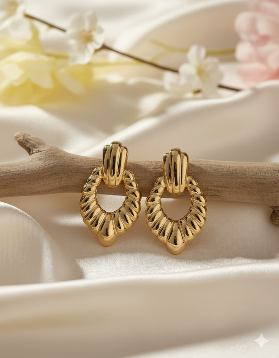 Statement Gold-Tone Croissant Textured Drop Earrings - ORYX TREND EaringMake a bold impact with these unique drop earrings. They feature a chunky, highly textural design, often referred to as a "croissant" or ribbed texture, in a rich gold tone. The earrings are secured with a simple, polished stud or post back. Made from durable stainless steel, these fashionable pieces are resistant to tarnishing, offering a high-end look with long-lasting quality. Perfect for elevating any outfit.Default Title#