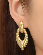 Statement Gold-Tone Croissant Textured Drop Earrings - ORYX TREND EaringMake a bold impact with these unique drop earrings. They feature a chunky, highly textural design, often referred to as a "croissant" or ribbed texture, in a rich gold tone. The earrings are secured with a simple, polished stud or post back. Made from durable stainless steel, these fashionable pieces are resistant to tarnishing, offering a high-end look with long-lasting quality. Perfect for elevating any outfit.Default Title#