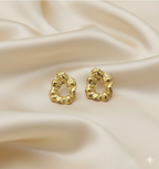 Statement Gold-Tone Molten Nugget Stainless Steel Earrings - ORYX TREND EaringA pair of bold and contemporary earrings featuring a distinctive, organic, "molten" texture. The abstract, irregular shape and hammered-look finish give them a high-fashion, artisanal appeal. Crafted from durable stainless steel and finished in a bright gold tone, these earrings are designed to be long-lasting and make a powerful statement. Perfect for adding a modern, sculptural touch to any outfit.Default Title#
