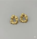 Statement Gold-Tone Molten Nugget Stainless Steel Earrings - ORYX TREND EaringA pair of bold and contemporary earrings featuring a distinctive, organic, "molten" texture. The abstract, irregular shape and hammered-look finish give them a high-fashion, artisanal appeal. Crafted from durable stainless steel and finished in a bright gold tone, these earrings are designed to be long-lasting and make a powerful statement. Perfect for adding a modern, sculptural touch to any outfit.Default Title#