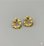 Statement Gold-Tone Molten Nugget Stainless Steel Earrings - ORYX TREND EaringA pair of bold and contemporary earrings featuring a distinctive, organic, "molten" texture. The abstract, irregular shape and hammered-look finish give them a high-fashion, artisanal appeal. Crafted from durable stainless steel and finished in a bright gold tone, these earrings are designed to be long-lasting and make a powerful statement. Perfect for adding a modern, sculptural touch to any outfit.Default Title#