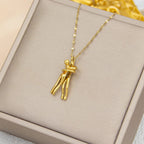 The Embrace Necklace: Gold-Tone Hug Pendant - ORYX TREND NecklaceA beautifully artistic necklace featuring a minimalist pendant design that captures the tender moment of an intimate embrace. The gold-tone pendant depicts two stylized figures locked in a hug, symbolizing love, connection, comfort, and friendship. Suspended from a delicate gold-toned chain (perhaps a flat link or paperclip style), this unique piece makes a deeply personal and meaningful gift for a loved one.Default Title#