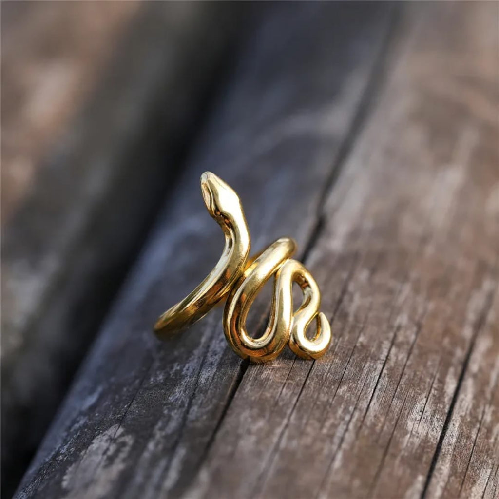 Gold spiral ring on a wooden surface